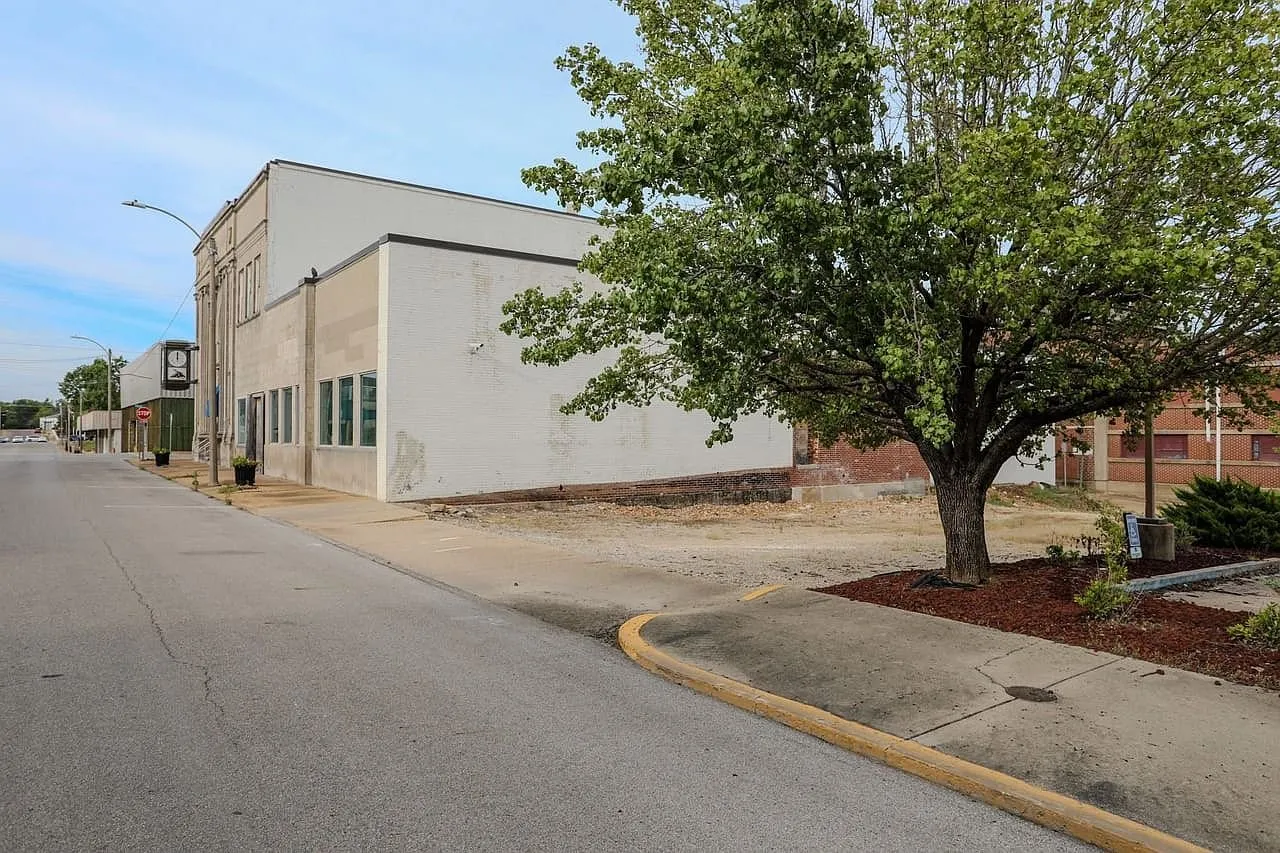 The building from the parking lot with a tree in front