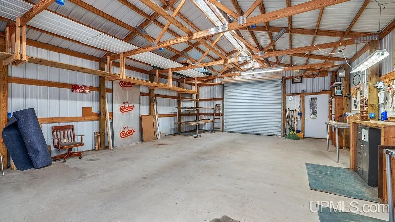 The garage interior with workbenches and storage along the walls
