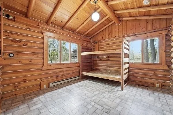 A bunk room with the built-in bunks and the windows