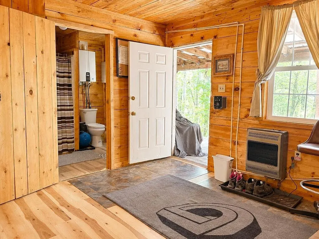 The entry with the propane wall heater and the bathroom door