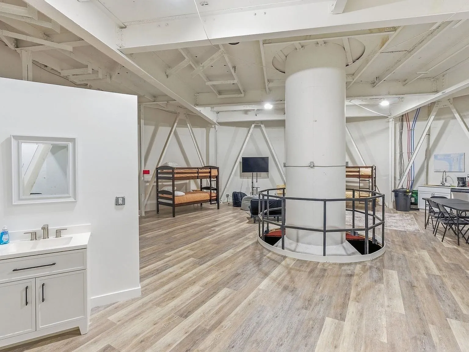 A furnished sitting area built inside the silo structure, bunk beds along the wall