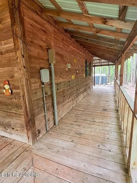 The back porch walkway leading toward the propane tank and utility area