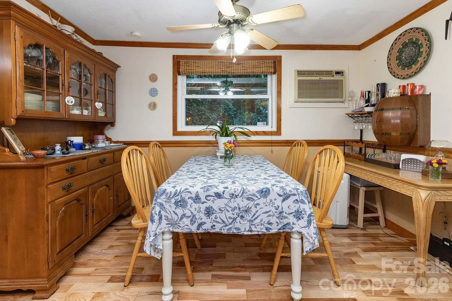 The dining room with the hutch, the table and the wall unit