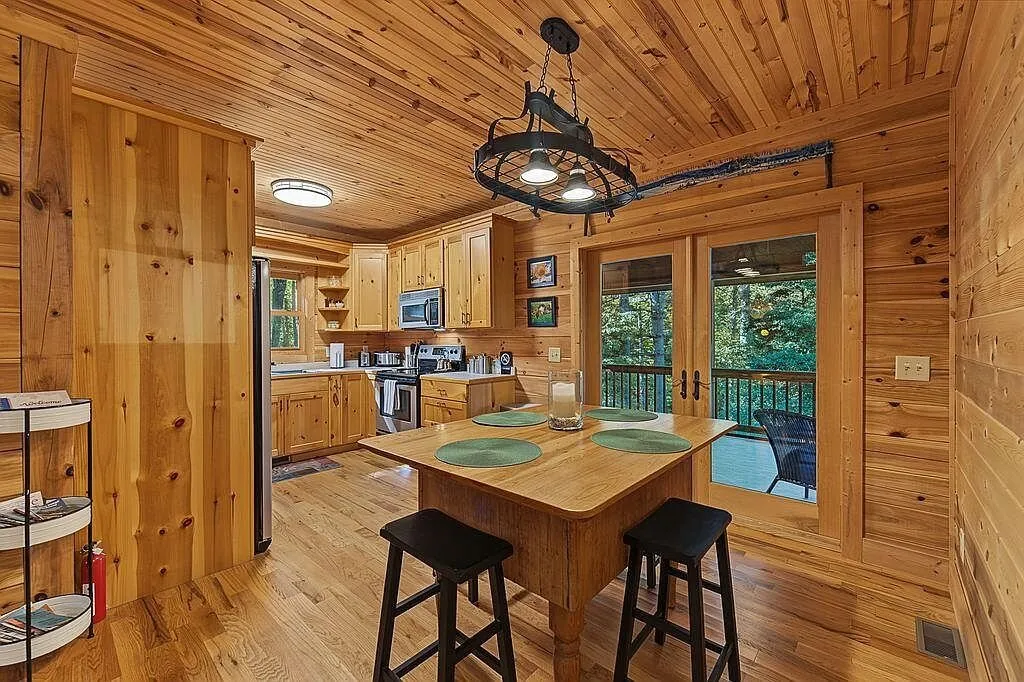 The kitchen's breakfast bar with wood countertops and pendant lighting