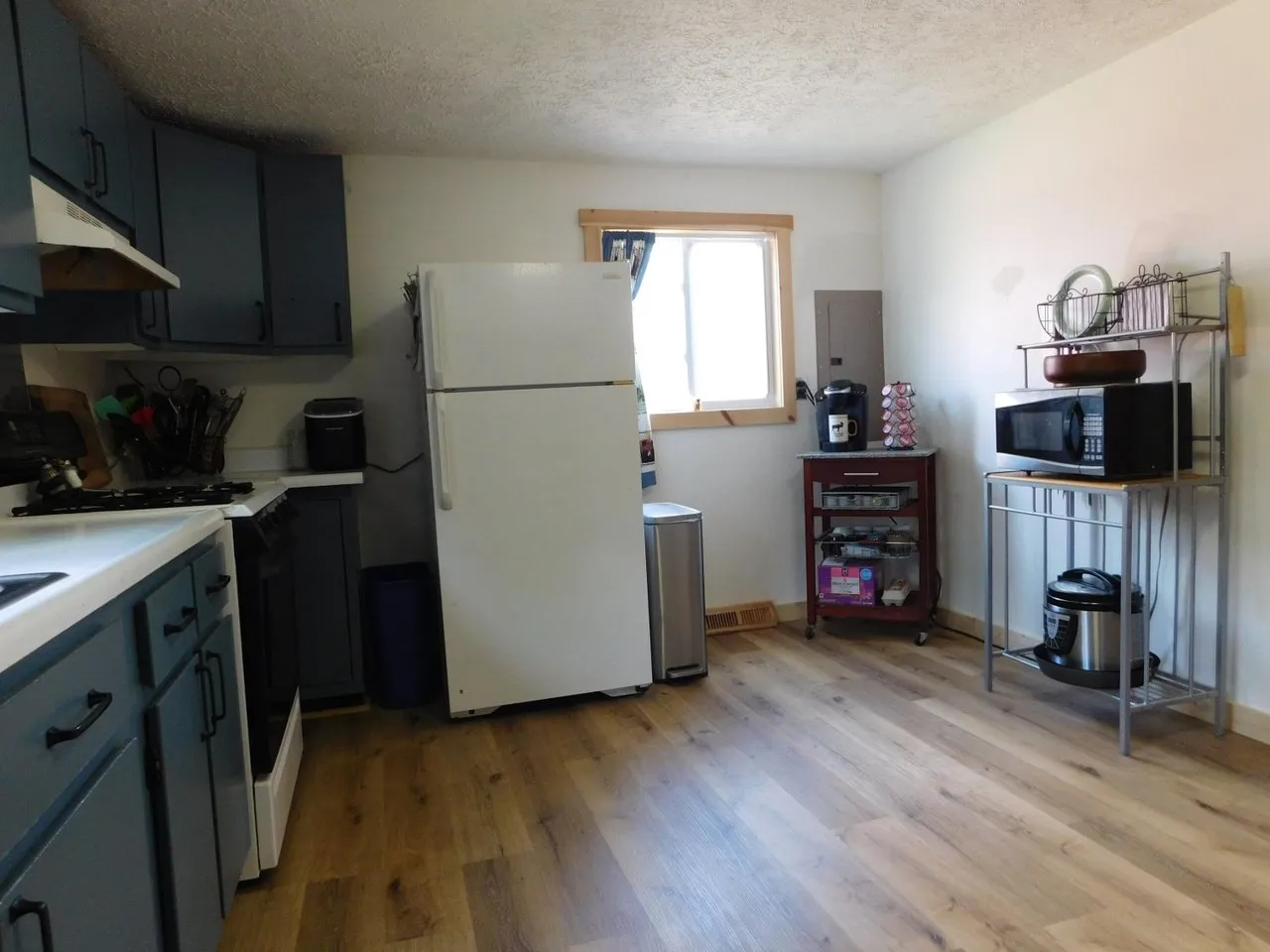 The kitchen from the dining side, laminate floor running through