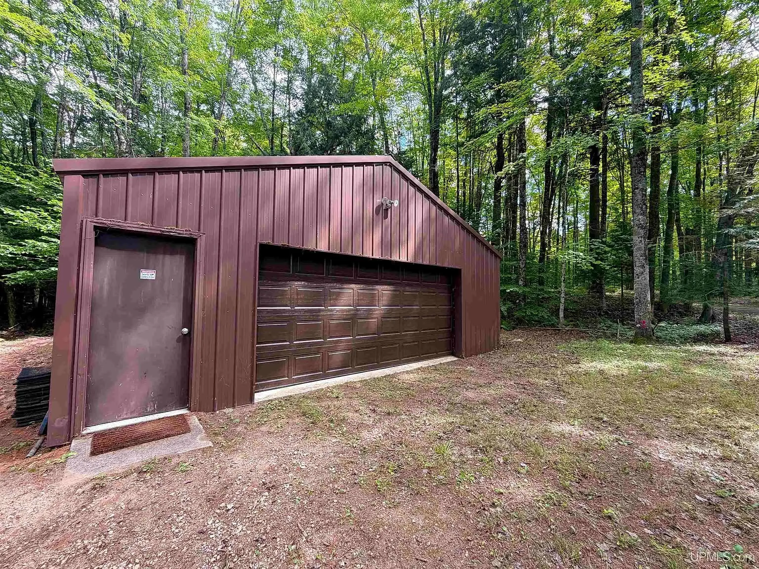 The steel pole barn with its overhead door