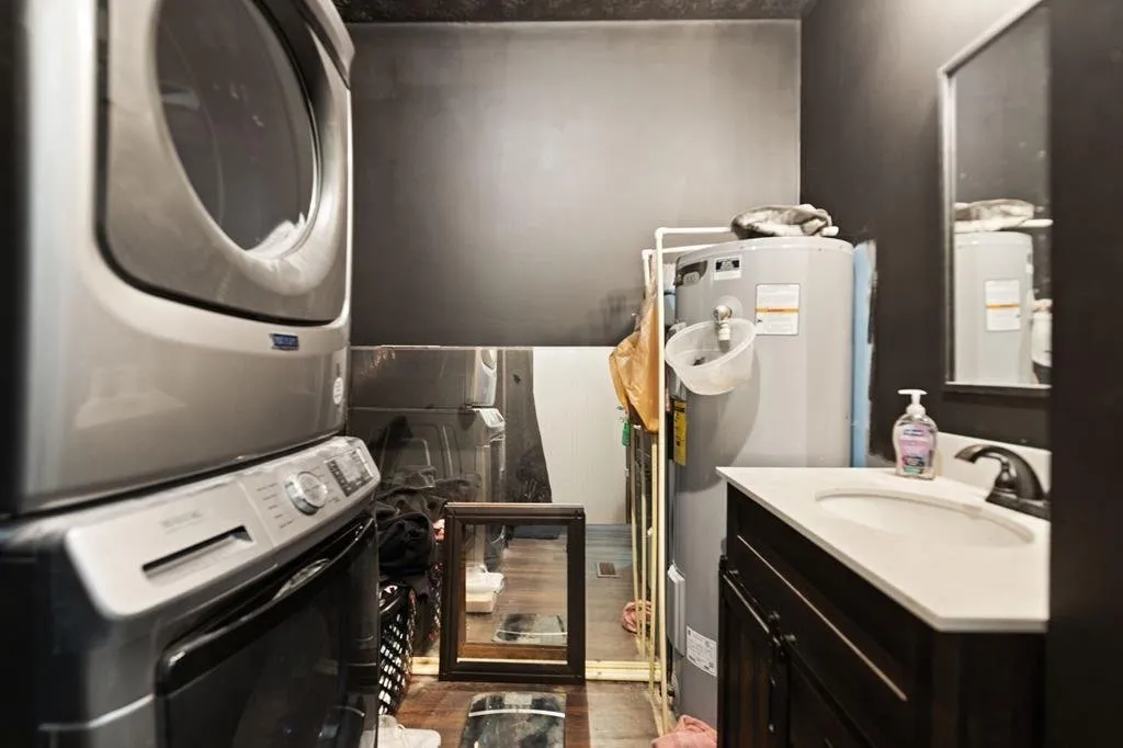 The stacked washer and dryer beside the bathroom vanity