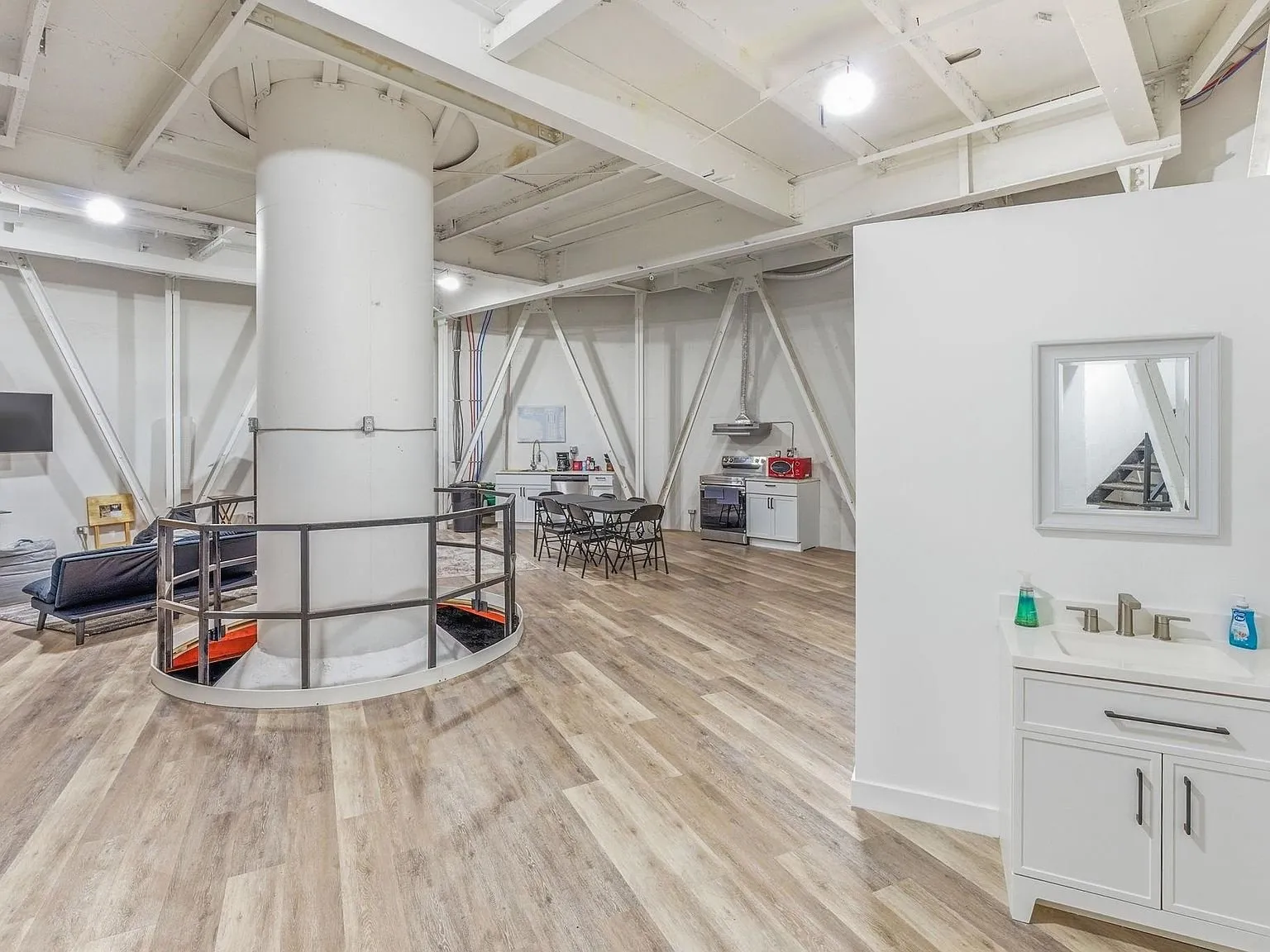 A kitchenette and dining table set inside the silo's steel framework
