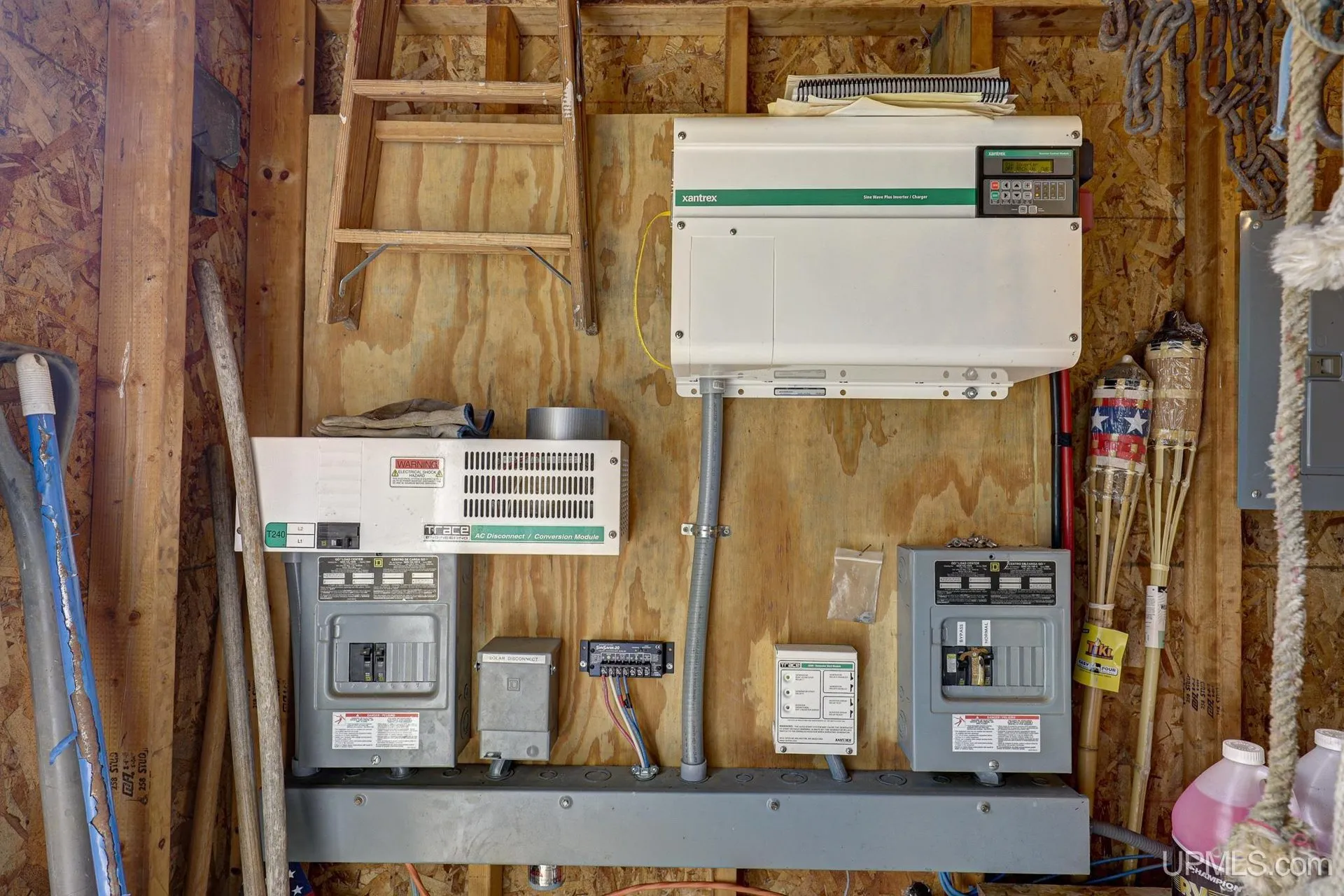 The solar and electrical panels mounted inside an outbuilding