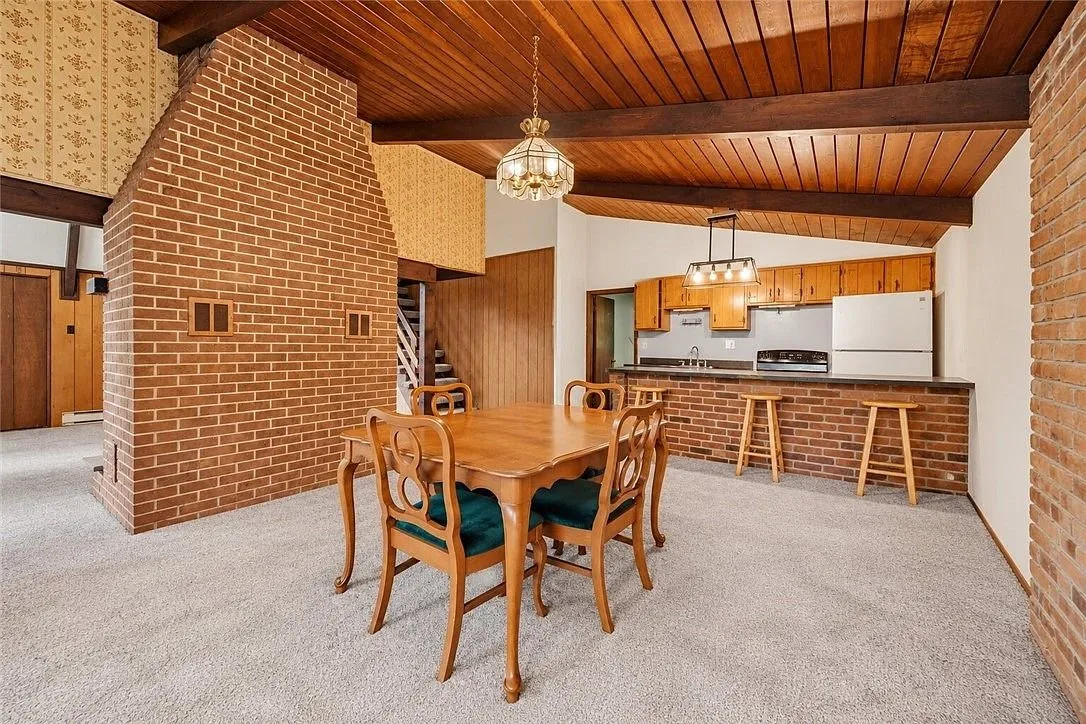 The A-frame loft under the exposed roof beams, hardwood floor