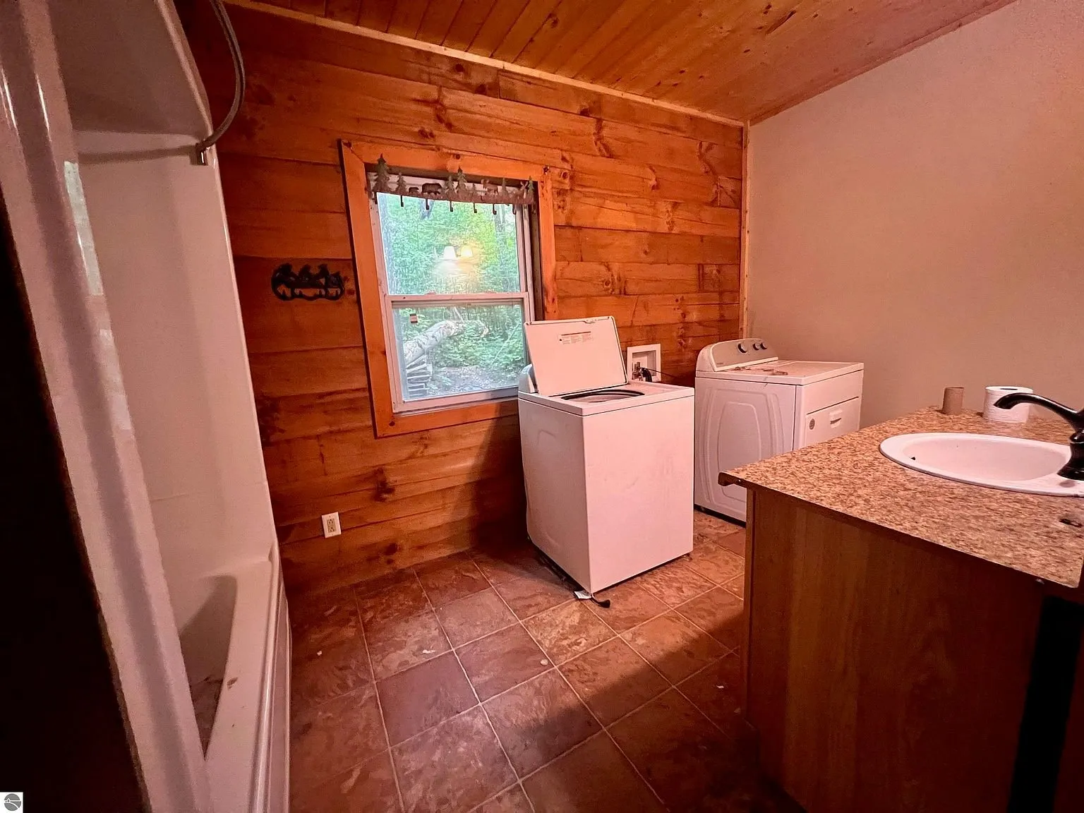 The laundry with the washer, the dryer and the sink