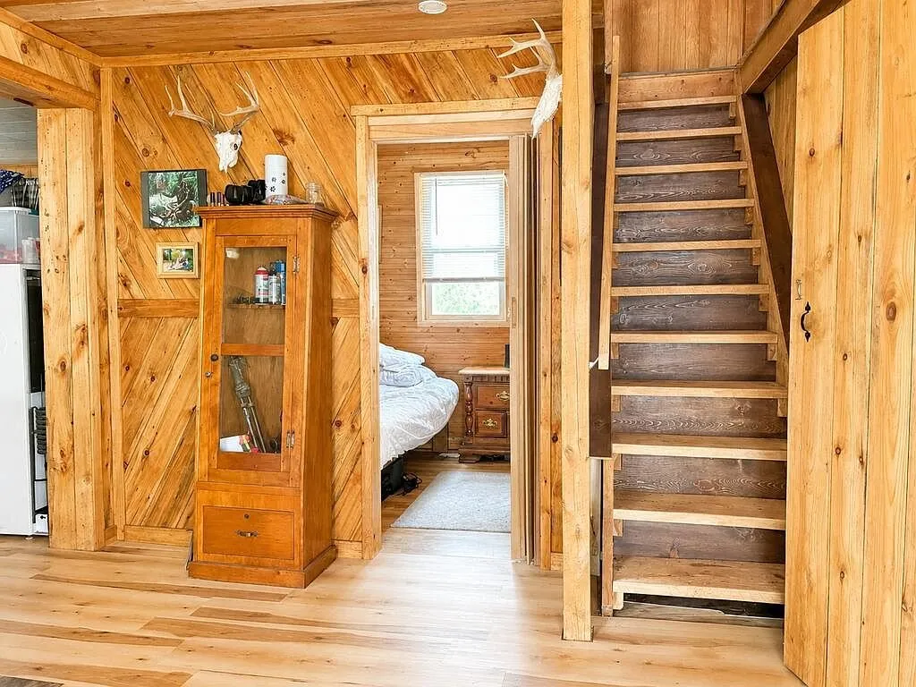 The open stairs to the loft beside the gun cabinet