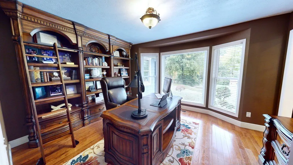The office with built-in bookshelves and a window onto the yard