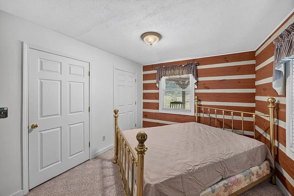 A second bed in the main-level bedroom near a closet and doorway