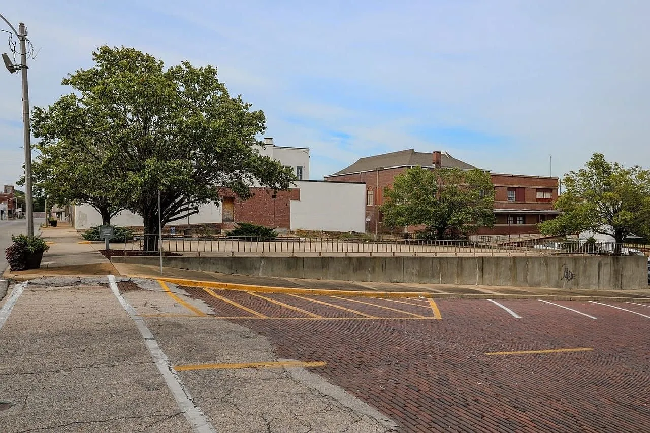 The brick street and the parking lot with its faded striping