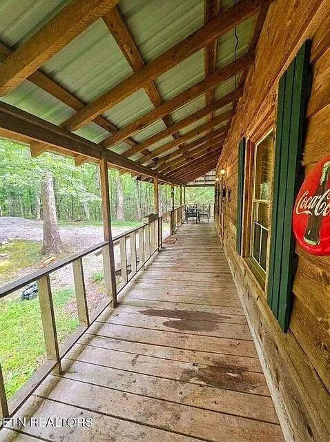 The front porch corner decorated with a Coca-Cola sign and green shutters