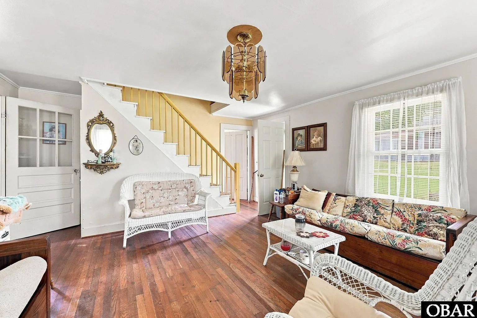 The living room from the front door with the stair and sofa