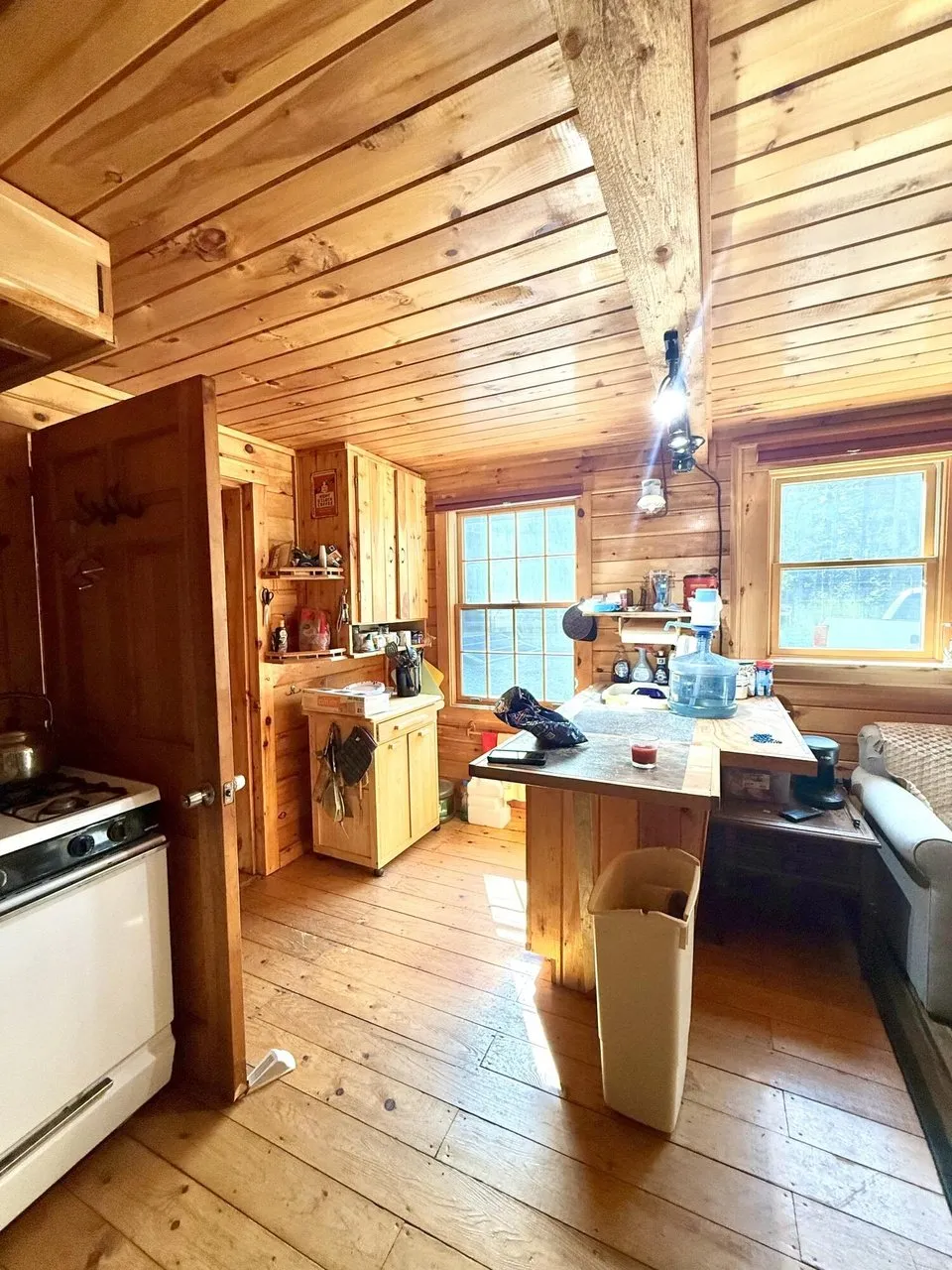 The kitchen counter with the window and the pine ceiling