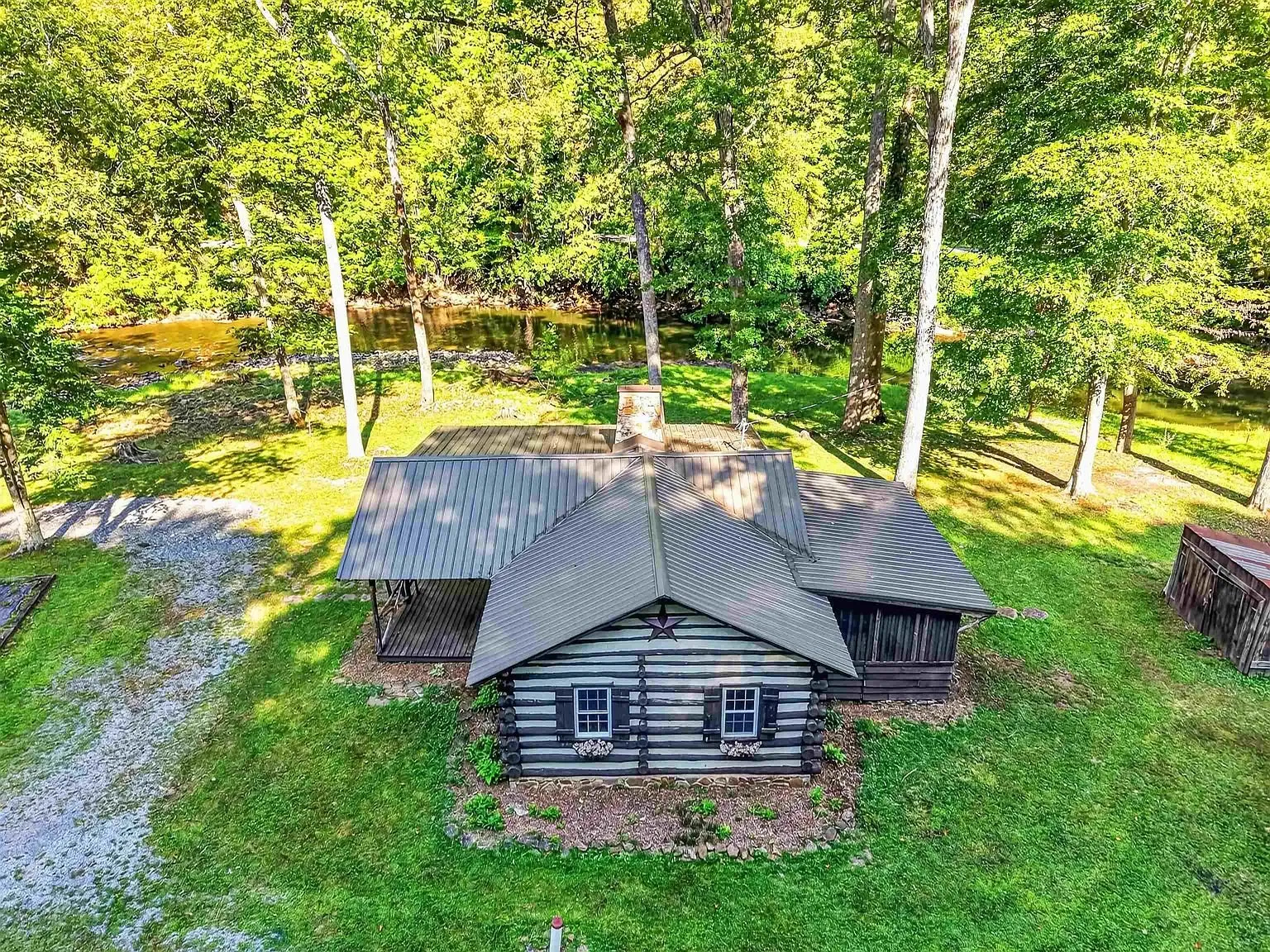 Aerial of the cabin and its clearing from low overhead