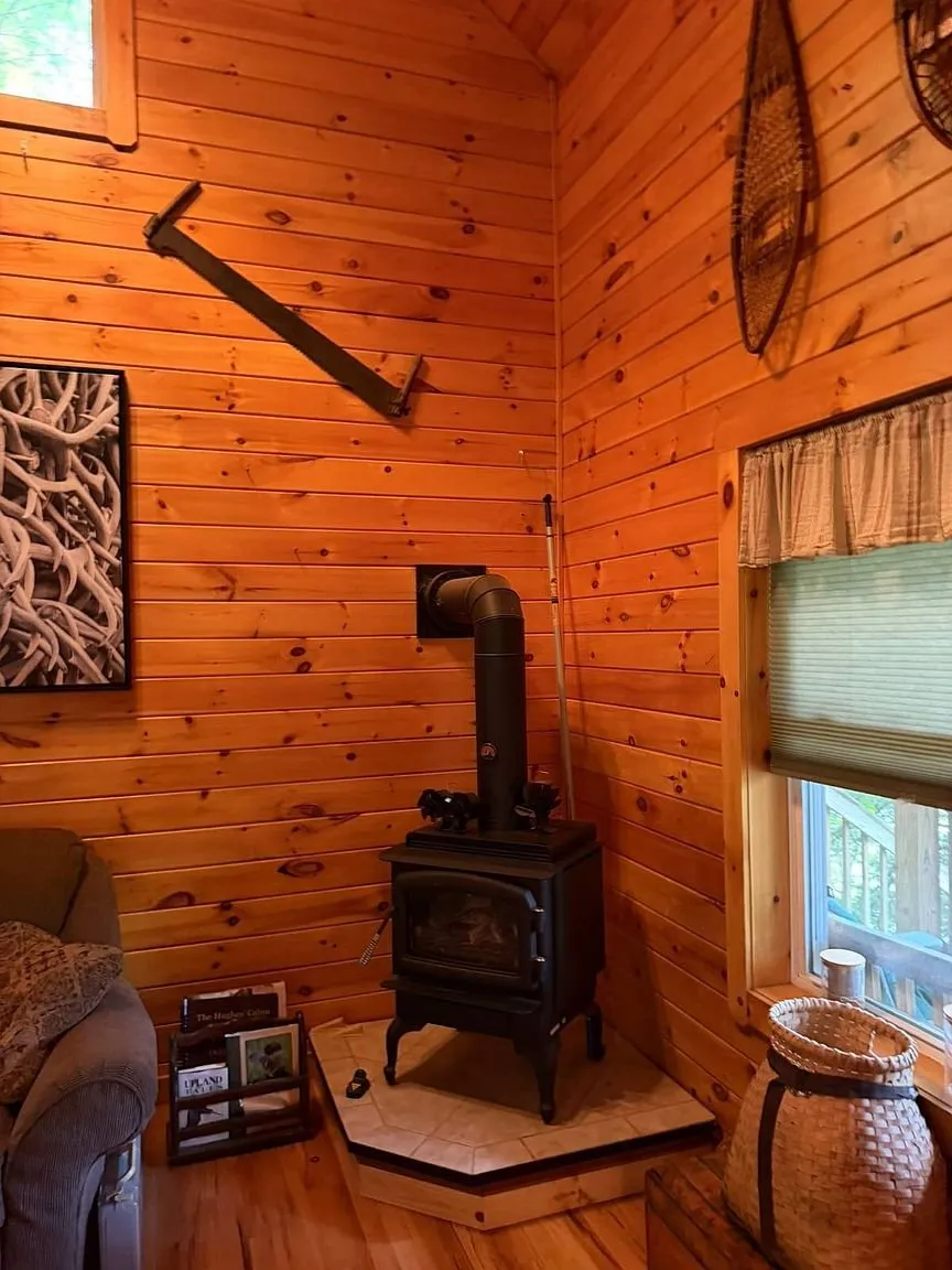 The propane stove in the corner with the window