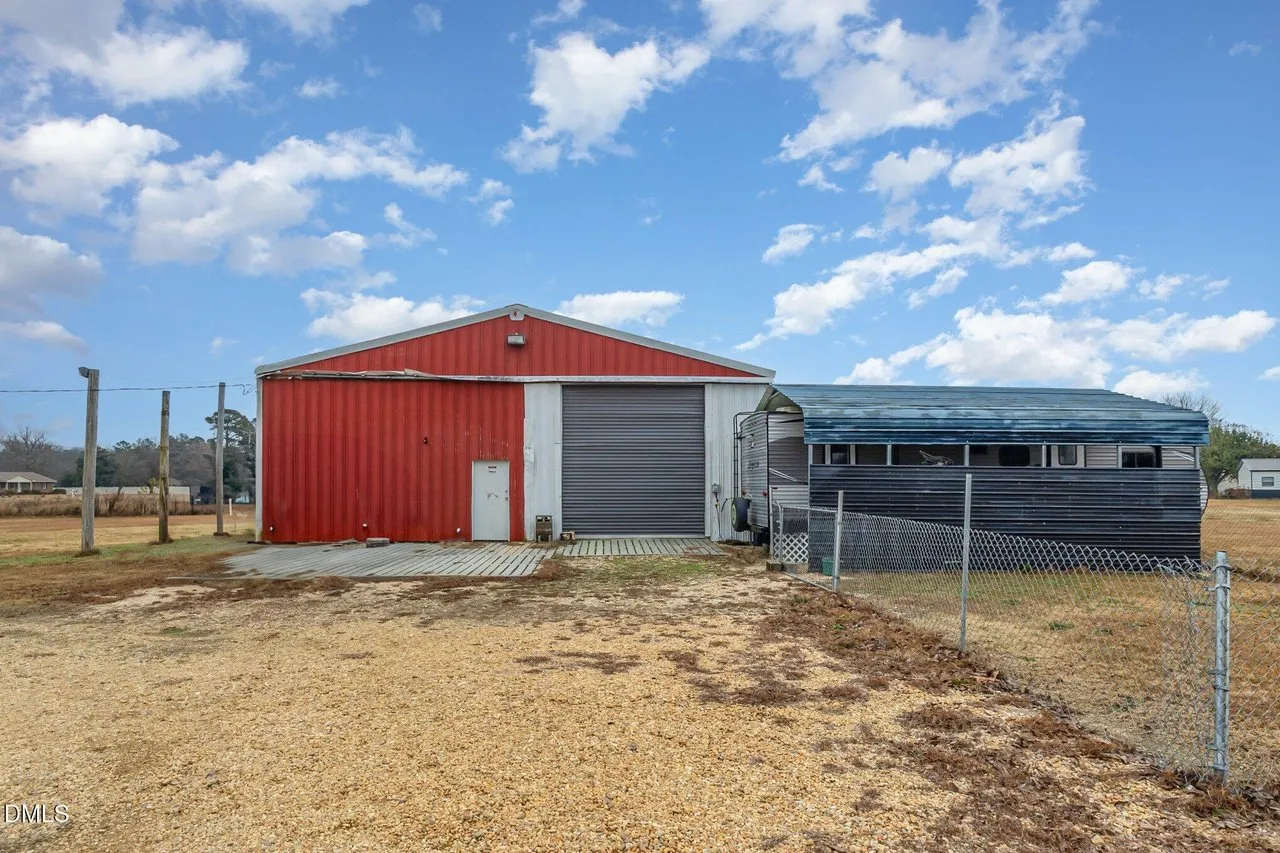 The red 60 by 43 metal workshop with two roll-up doors
