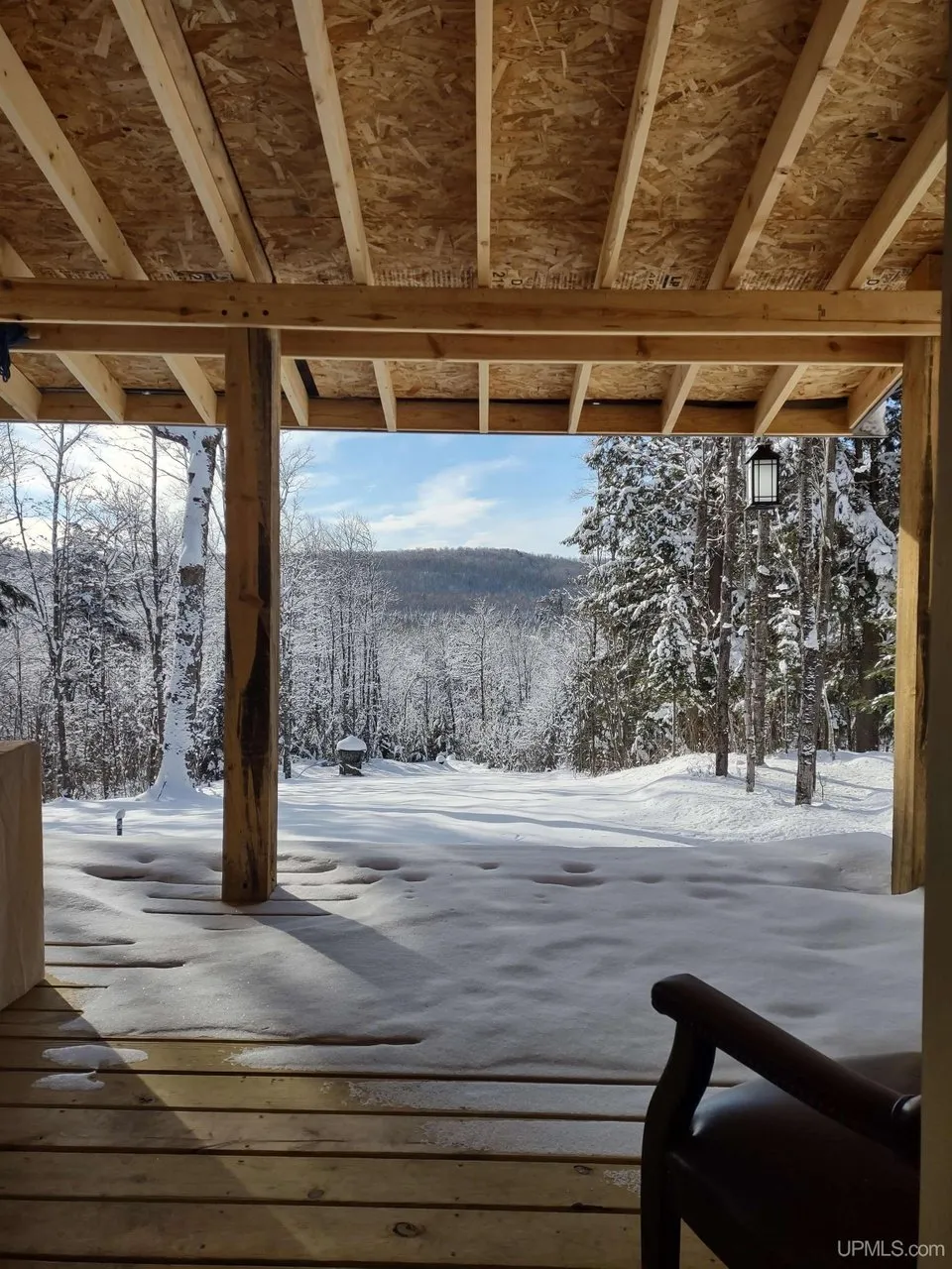The view from the covered deck out over snow
