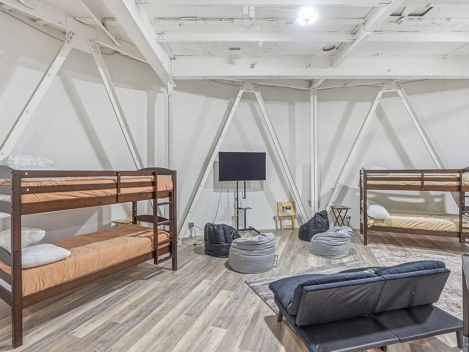 Bunk beds and seating arranged inside the silo's open interior