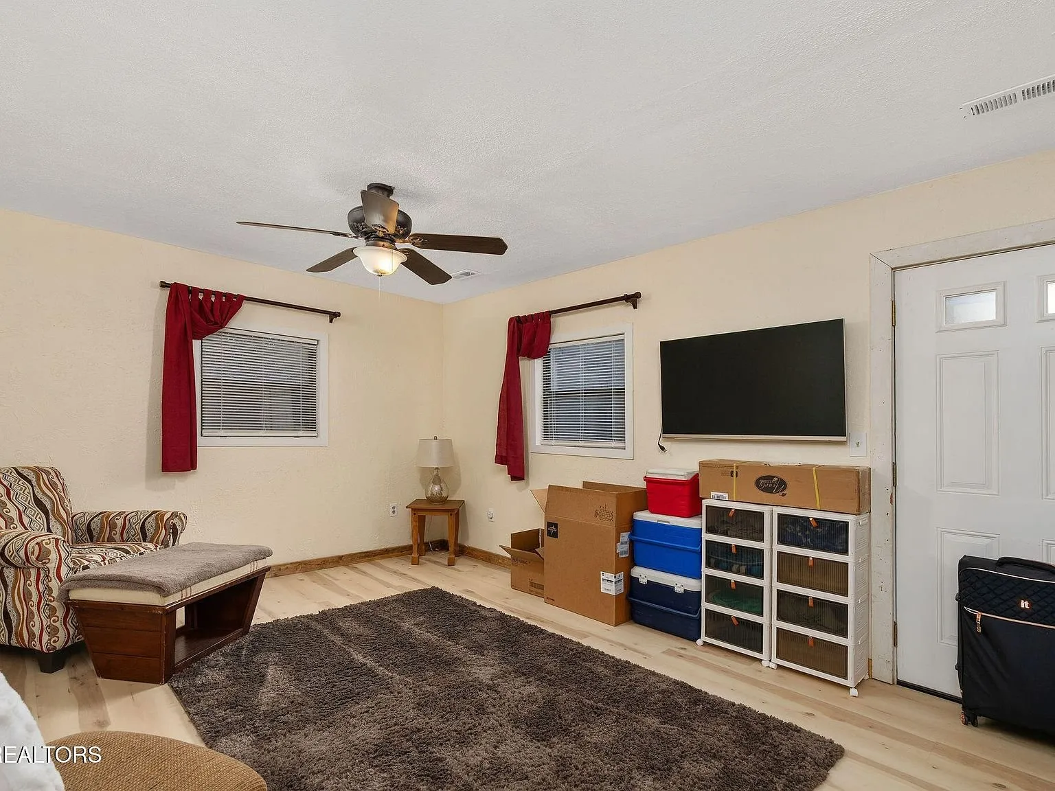A second angle of the living area with upholstered seating