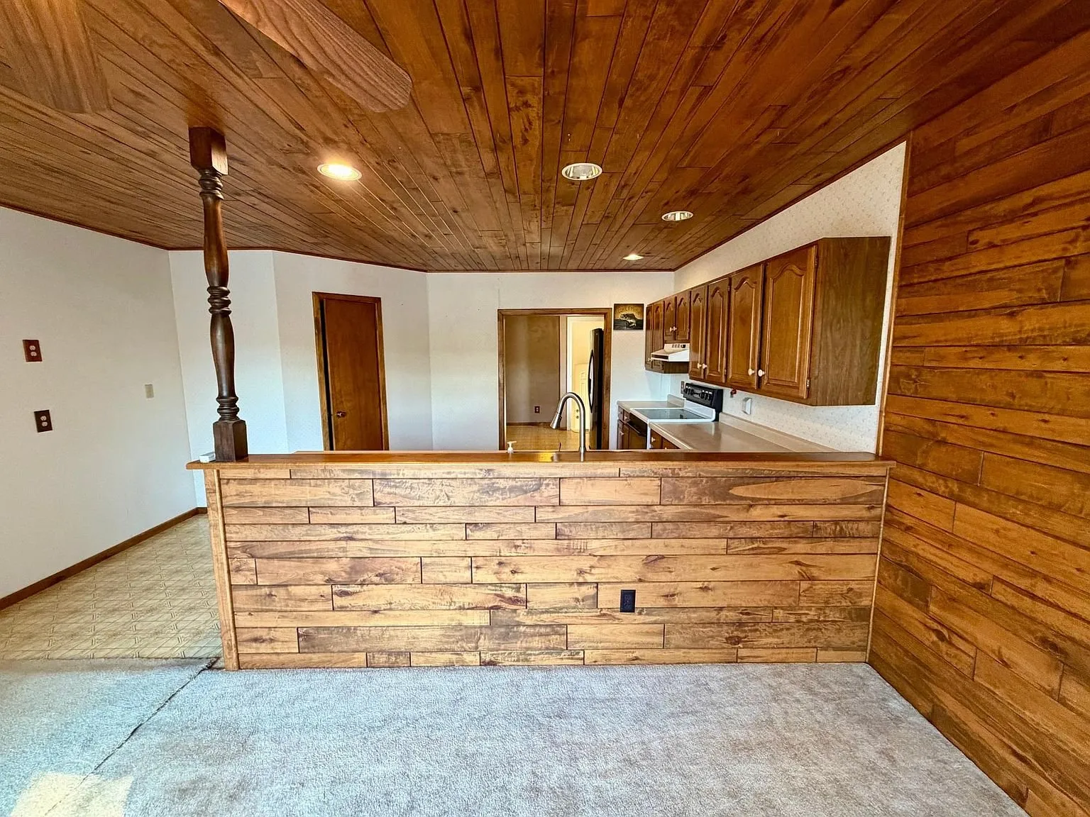 The kitchen bar with the wood front from the living room