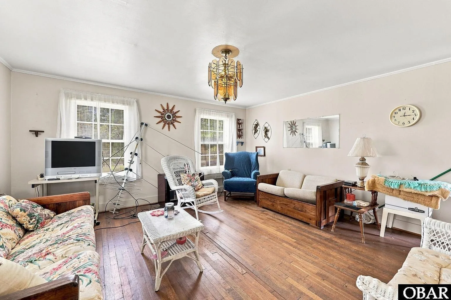 The living room with its wood floor and furniture