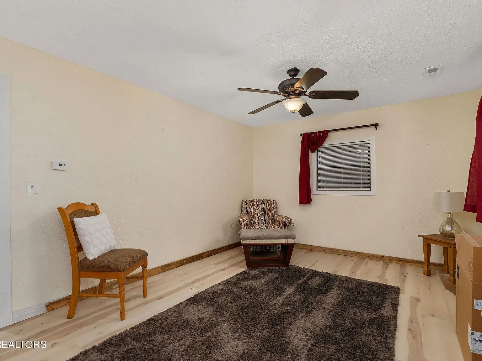 The living area opening toward a staircase and side room