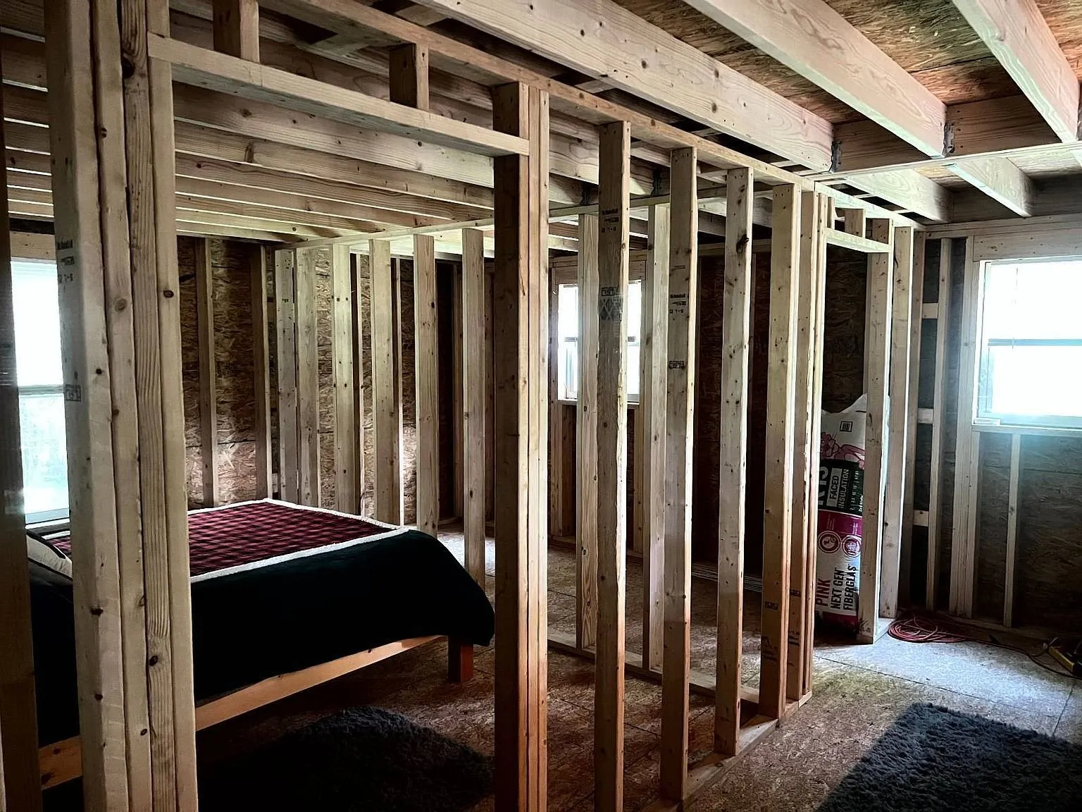 The framed partition walls with a bed beyond