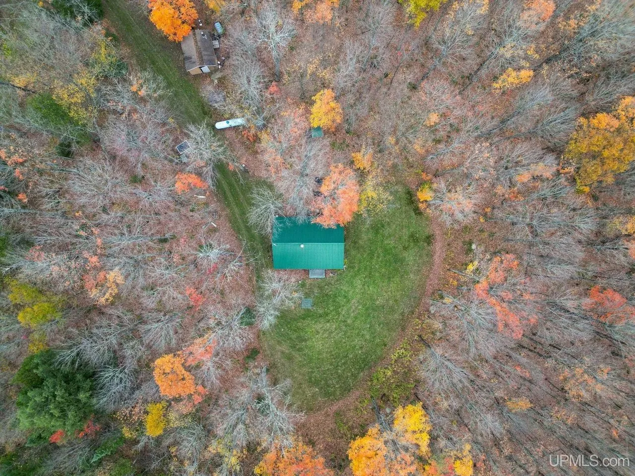 Aerial straight down on the cabin and its clearing with the two-track running in