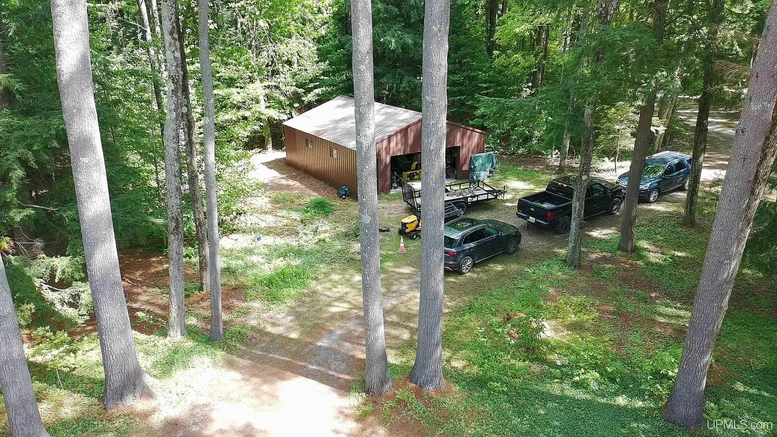 Aerial of the buildings and vehicles among the pines