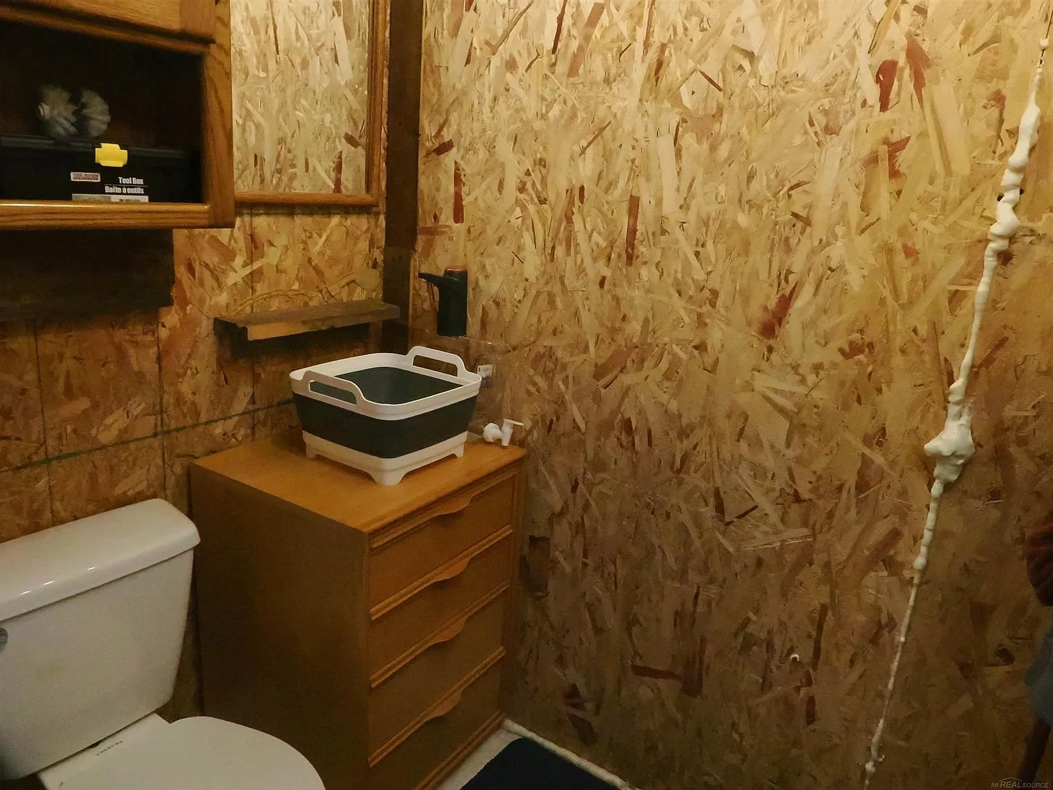 The half bath with the toilet and the cabinet