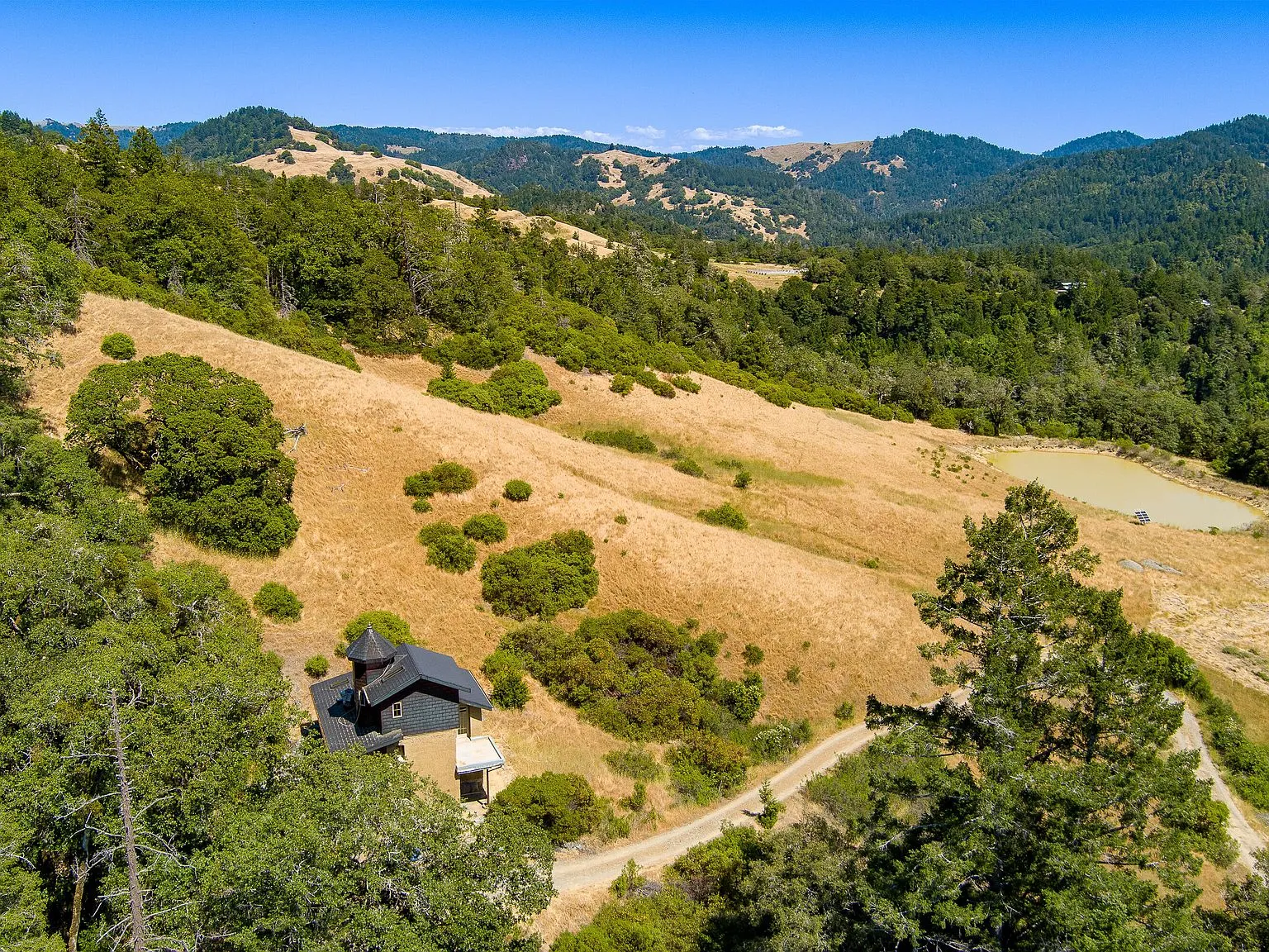 An aerial view of the pond and rolling hills surrounding the property