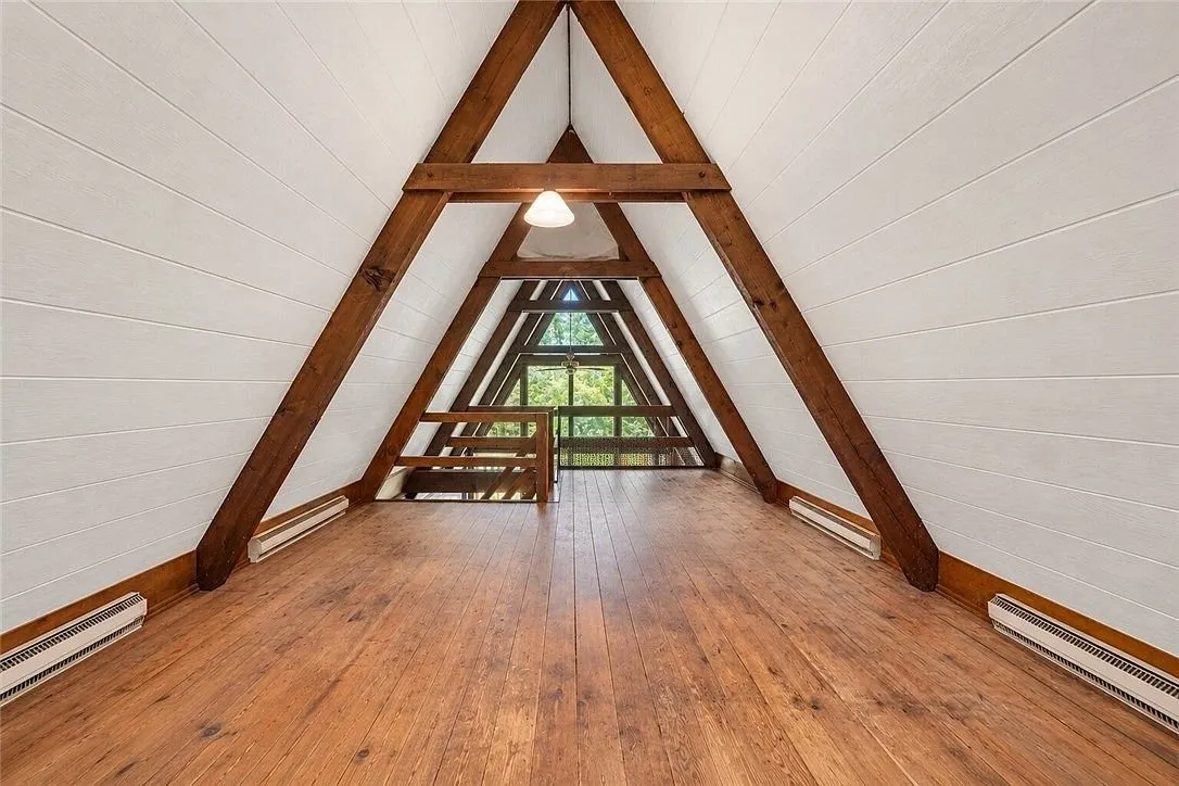 The loft stairs and the beams meeting at the ridge