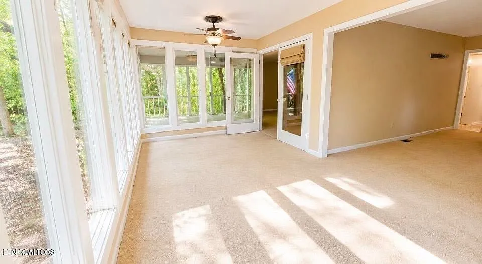 The sunroom with windows on three sides