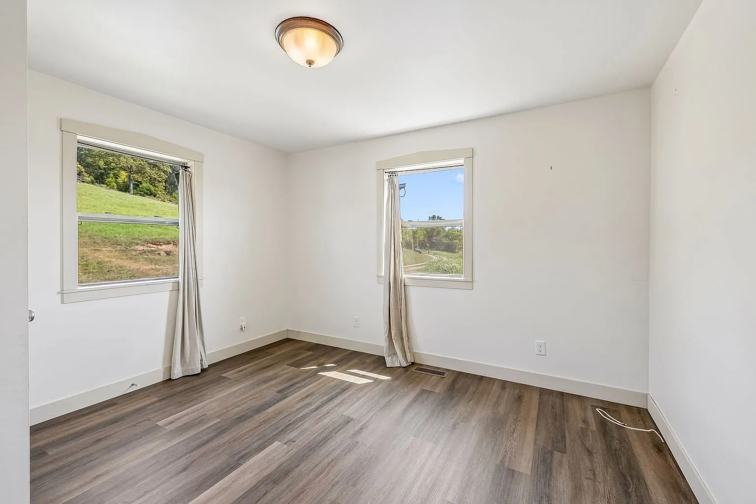 The main level bedroom with two windows