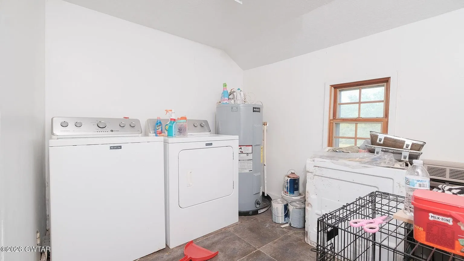The utility room with the washer, dryer and electric water heater