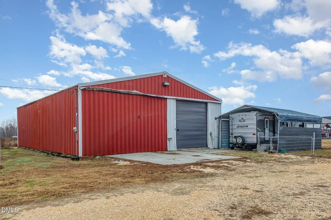 The shop from the side with the detached garage and carport next to it