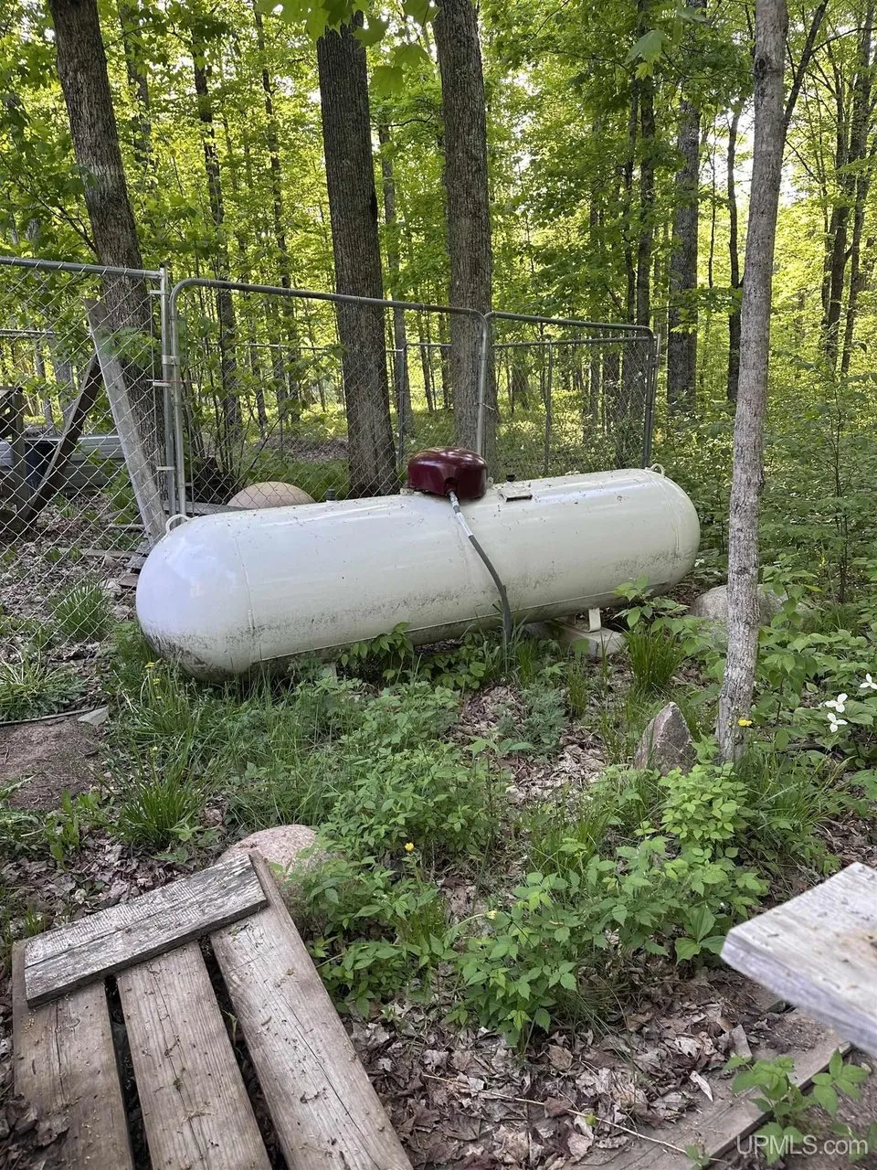 The leased propane tank in the trees