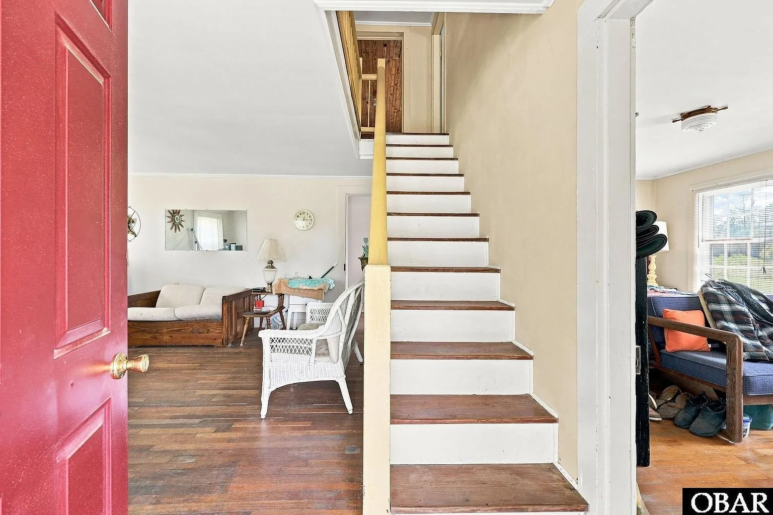 The stair from the entry with the red front door