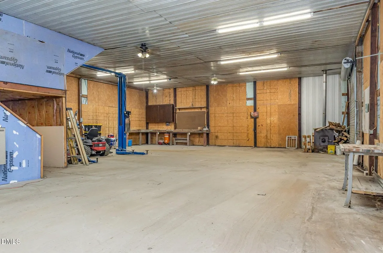 Inside the shop: the two-post car lift, workbenches and roll-up doors