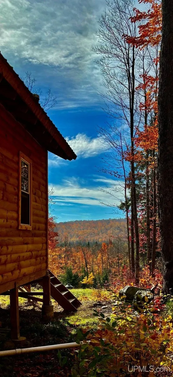 The corner of the cabin against an autumn sky