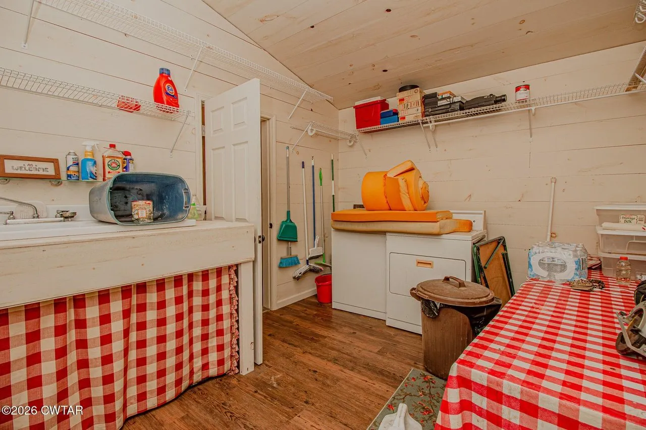 The utility room with a counter, sink and storage
