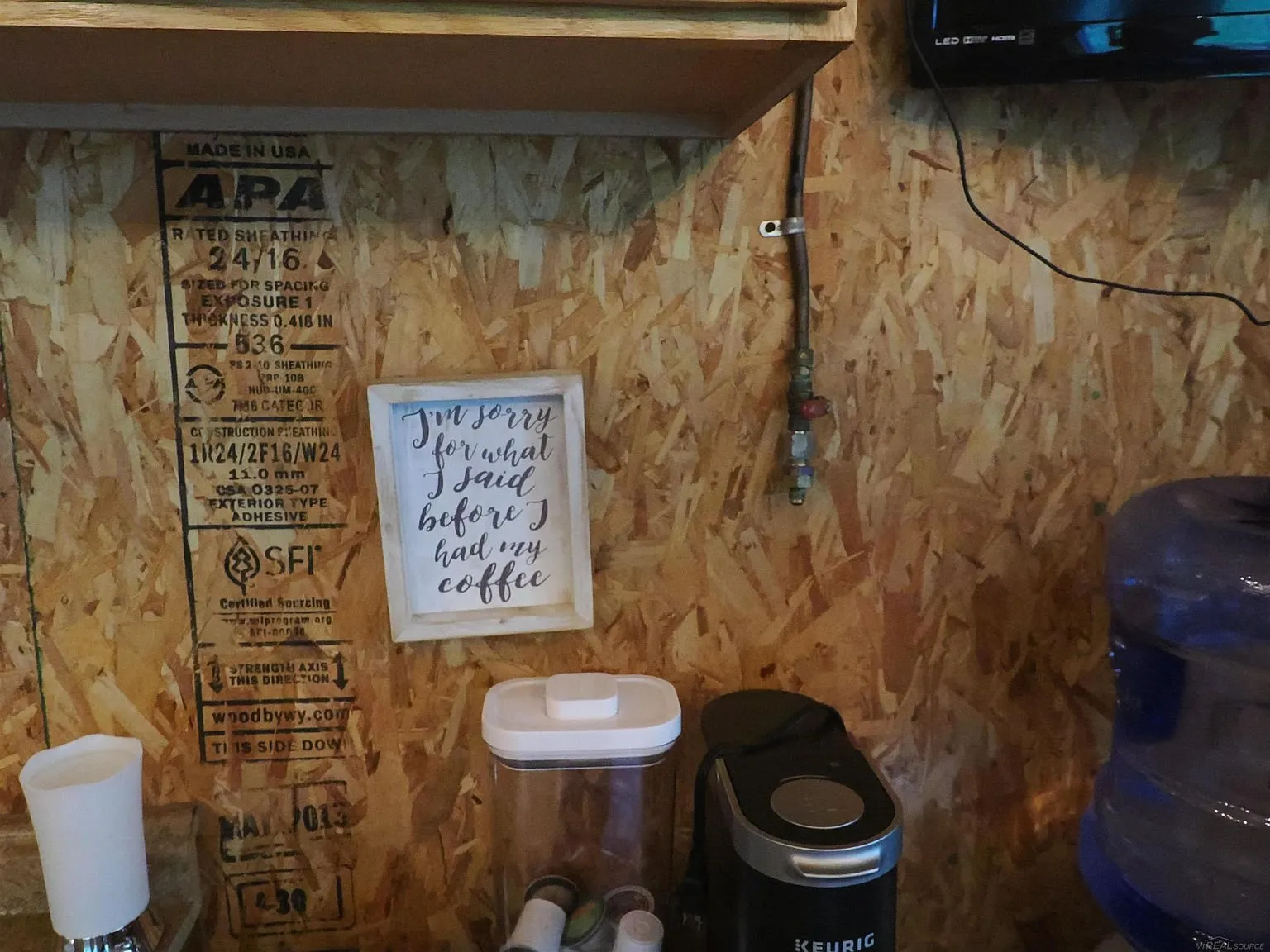 The coffee maker and the water jug on the counter