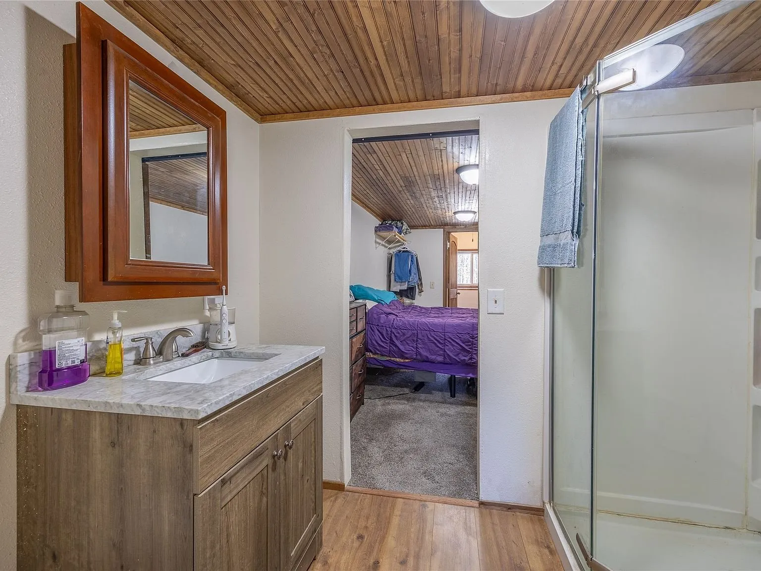 A second bedroom with a bed and nightstand
