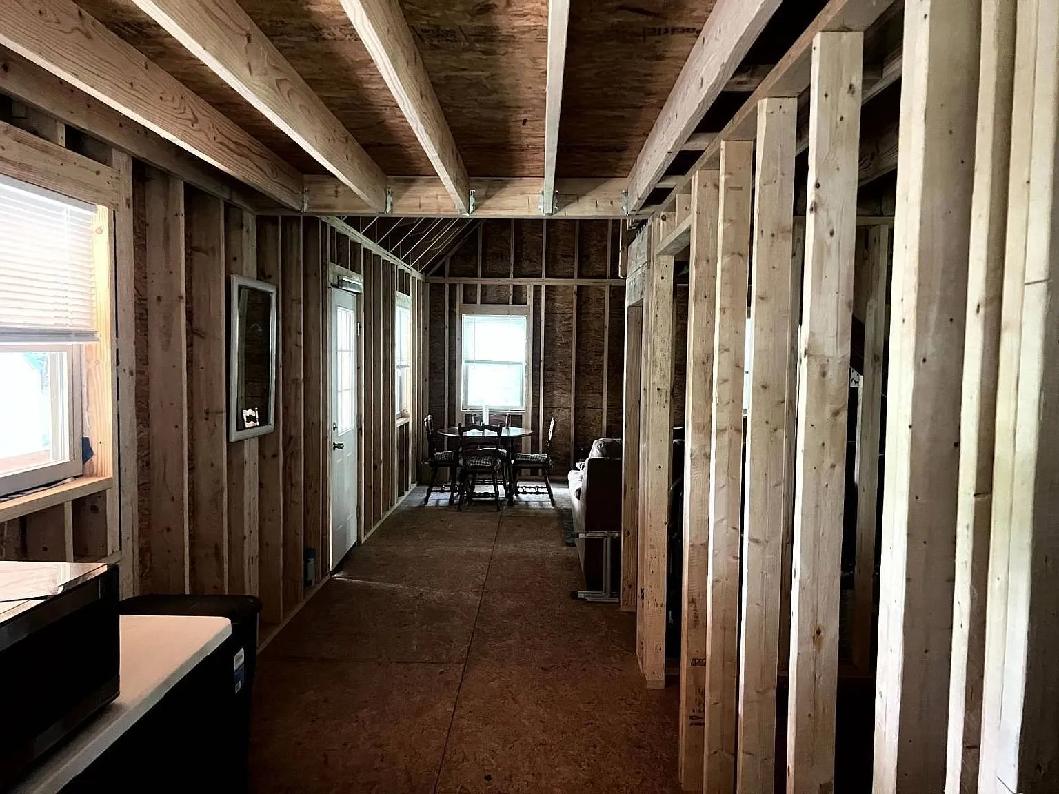 Looking down the cabin through the open framing to the far windows