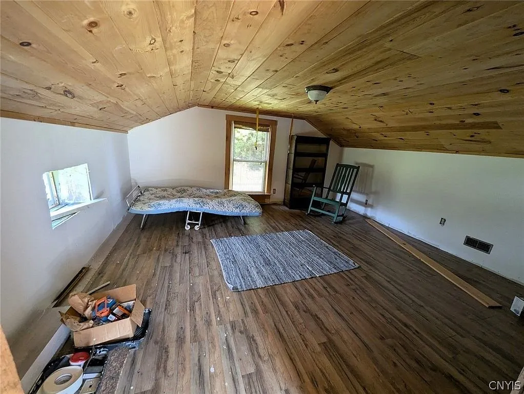 The upstairs room under the pine ceiling with a mattress